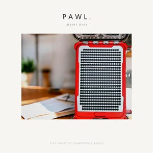 May include: A red storage insert with a grid of small circular holes, featuring the text PAWL. INSERT ONLY and FITS PACKOUT-COMPATIBLE BOXES. The insert has a light gray interior panel with a repeating pattern of horizontal rows of circular cutouts.