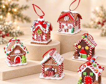May include: Six miniature gingerbread house ornaments featuring brown walls, white icing details, red and white candy cane accents, and colorful gumdrop decorations. Each house includes a red ribbon loop for hanging on a holiday tree.
