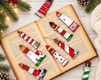 May include: A collection of eight lighthouse ornaments featuring red, white, and green painted details. Each lighthouse has a distinct striped or solid pattern, a lantern room at the top, and a base, with some including attached hanging strings.