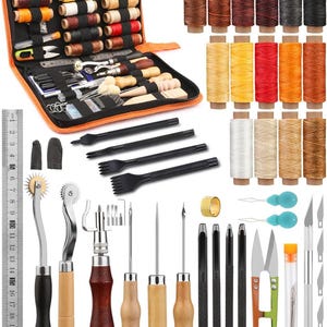May include: A leathercraft tool kit with various tools, including needles, scissors, and a ruler. The kit includes spools of thread in multiple colors, a case, and other accessories. The ruler is marked in inches and centimeters.