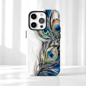 May include: A white smartphone case featuring a watercolor illustration of multiple peacock feathers. The design displays vibrant shades of blue, green, and brown, with the characteristic eye-shaped patterns of the feathers arranged vertically.