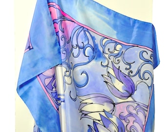 May include: A blue silk scarf with a pink and white floral pattern. The scarf is draped over an easel.
