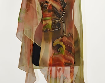 May include: A sheer silk scarf with a hand-painted design of leaves in shades of green, brown, orange, and gold. The scarf is draped over a mannequin.