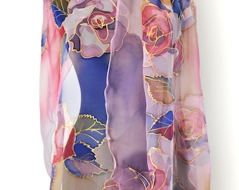 May include: A sheer silk scarf with a floral design featuring pink, purple, and blue roses with gold accents. The scarf is draped over a mannequin.