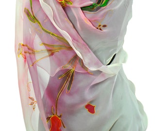 May include: A white silk scarf with a pink and green floral design. The scarf is draped over a mannequin.