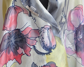 May include: A silk scarf with a watercolor design of pink, red, and blue poppies on a light gray background. The scarf has a label that reads "Sady-Ea Couture".