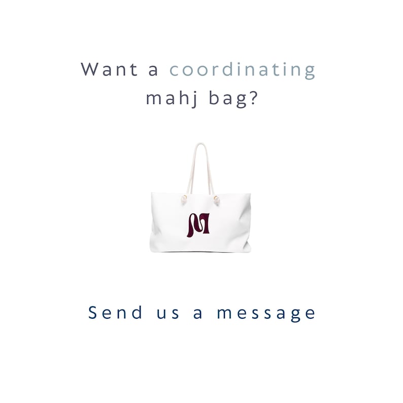 May include: A white tote bag with two white rope handles and a dark maroon letter M logo on the front. The text above the bag reads "Want a coordinating mahj bag?" and the text below the bag reads "Send us a message" in dark blue lettering.