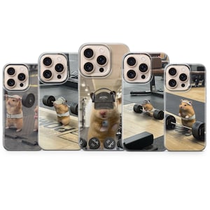 May include: Five phone cases featuring a cartoon hamster lifting weights in a gym setting. The hamsters are wearing hats and headbands. The cases are clear with a printed design.