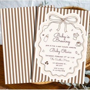 May include: A folded baby shower invitation card with a brown and white vertical striped pattern. The front features a scalloped cream-colored frame with a bow, coffee-themed illustrations, and the text Baby is Brewing, Baby Olivia.