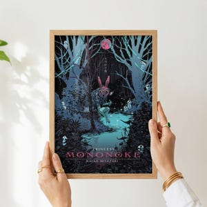 May include: A framed art print featuring a scene from Princess Mononoke. The artwork depicts a forest with a figure wearing a rabbit mask. The title and artist's name are displayed in pink and white text at the bottom.