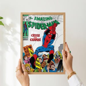 May include: A framed vintage comic book cover of The Amazing Spider-Man. The cover features Spider-Man in a red and blue suit, with the title in green and white. The comic is titled "Crisis on Campus!" and includes a crowd of people holding signs.