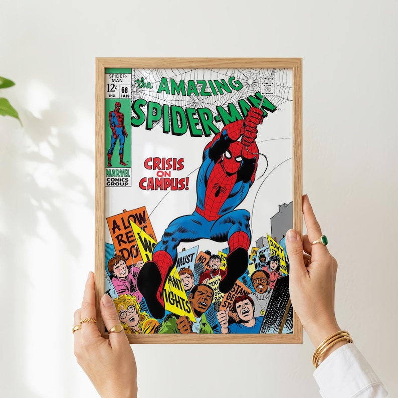 May include: A framed vintage comic book cover of The Amazing Spider-Man. The cover features Spider-Man in a red and blue suit, with the title in green and white. The comic is titled "Crisis on Campus!" and includes a crowd of people holding signs.