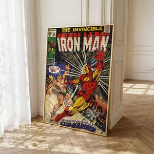 May include: A framed vintage comic book cover featuring Iron Man in a dynamic pose. The artwork is vibrant with red, yellow, and blue hues, showcasing a battle scene with the Submariner. The text "IRON MAN" is prominently displayed.