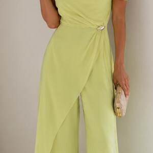 May include: A lime green one-shoulder jumpsuit featuring a draped bodice, a side waist accent with a metallic detail, and wide-leg trousers with an overlapping front panel design. The garment is floor-length and has a smooth, solid-colored fabric.