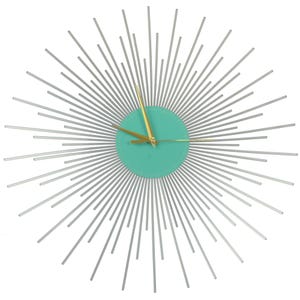 May include: A silver metal starburst wall clock with a turquoise center and gold hands. The clock's design features radiating silver rods extending from the center, creating a sunburst effect. The clock hands are gold.
