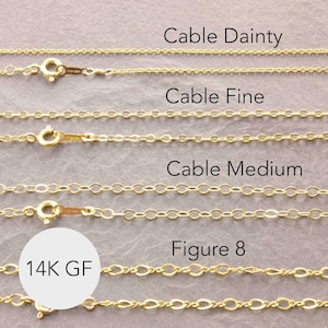 May include: Close-up of several gold-colored chain necklaces. The image displays different styles, including Cable Dainty, Cable Fine, Cable Medium, and Figure 8. The necklaces are shown with clasps and the text "14K GF".
