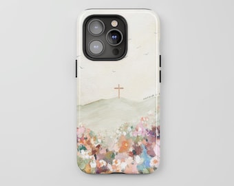 Pode incluir: Uma capa de smartphone com uma pintura impressionista de uma paisagem com uma cruz no topo de uma colina. O primeiro plano é preenchido com um padrão floral denso e colorido em tons de rosa, laranja, azul e verde sobre um céu pálido.