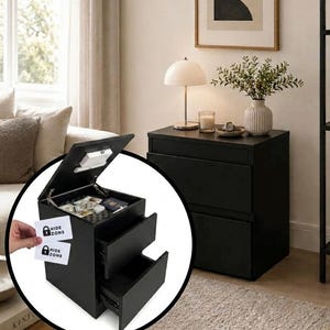 May include: A black nightstand with two lower drawers and a top compartment that opens upward to reveal a hidden storage area. The interior of the top compartment contains cash and a passport. A white card with the text HIDE ZONE is visible.
