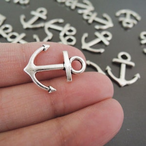 May include: Silver anchor charms, a popular choice for jewelry making and crafting projects. These small, detailed anchors are perfect for adding a nautical touch to necklaces, bracelets, earrings, and more.