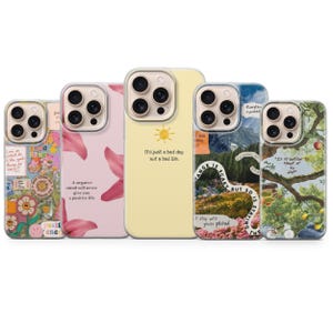 Pode incluir: Uma coleção de cinco capas de telefone com vários designs e citações. As capas apresentam padrões florais, frases inspiradoras e imagens de paisagens. Uma capa tem um fundo amarelo com um sol e o texto "It's just a bad day, not a bad life."