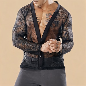 May include: Black lace cardigan with a V-neck and long sleeves. The cardigan has a satin trim and button closure. The garment is see-through and has a delicate floral pattern.