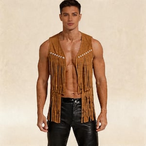 May include: A brown suede vest with fringe detailing and pearl-like studs along the edges. The vest has a V-neck and is sleeveless. The vest is worn with black leather trousers.