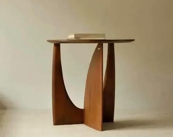 Mesita auxiliar escultural de madera oscura con base arqueada y tapa redonda, estilo nórdico japonés, mesa auxiliar para sofá de salón, decoración minimalista para el hogar.