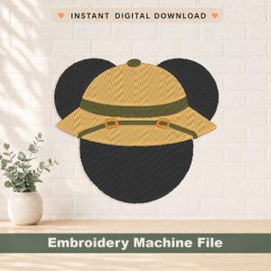 May include: An embroidered design of a safari hat with a dark green band and buckle details, above a black shape. The text "INSTANT DIGITAL DOWNLOAD" and "Embroidery Machine File" are displayed.