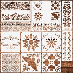 May include: A collection of white stencils with various floral and bird designs. The stencils include sunflowers, decorative borders, and repeating patterns. The stencils are arranged on a wooden surface, showcasing their intricate cut-out designs.