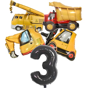 May include: A collection of foil balloons featuring a yellow crane truck, a red and yellow dump truck, a yellow excavator, a yellow forklift, and a large black number three balloon. These metallic balloons depict construction vehicles.