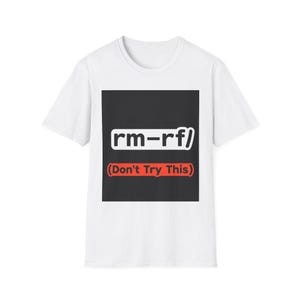 May include: White t-shirt with a black square graphic. The graphic features the text "rm-rf/" in white, and below it, the text "(Don't Try This)" in red. The shirt is a casual, everyday wear item.