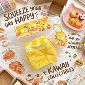 May include: A collection of kawaii bakery-themed collectibles. The image features a large, yellow, bread-shaped item in a clear bag, surrounded by stickers, miniature pastries, and a pen shaped like a burger. Text includes "Squeeze Your Day Happy" and "Kawaii Collectibles."