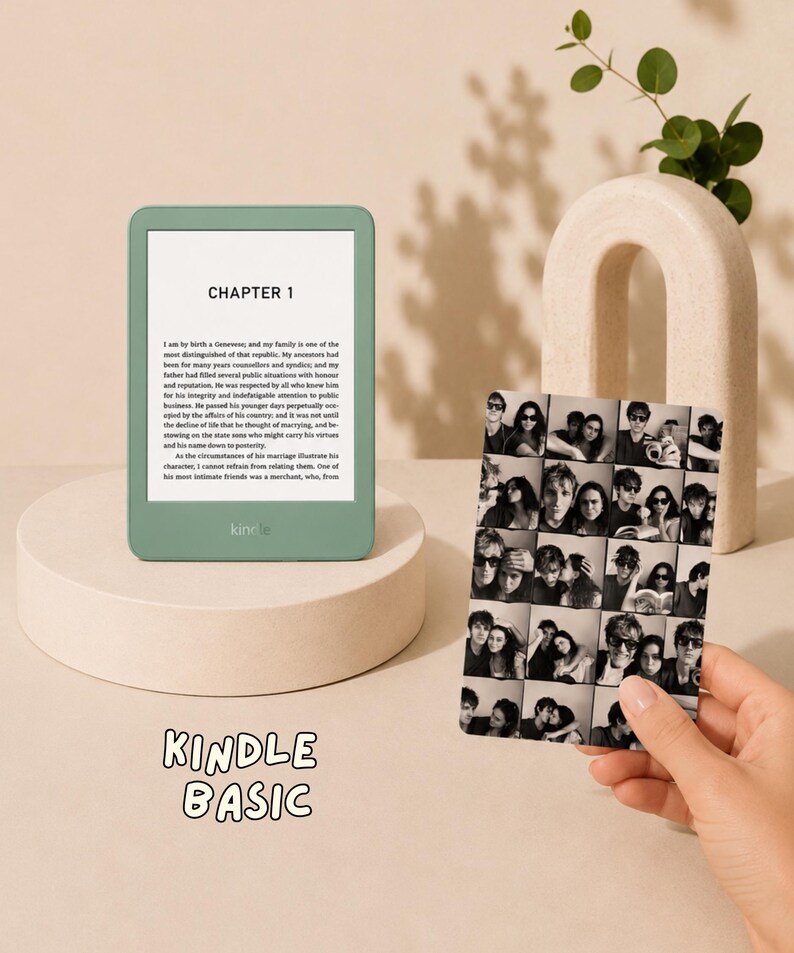 May include: A sage green Kindle Basic e-reader displaying Chapter 1 text on its screen, positioned next to a rectangular photo collage print featuring multiple black and white portraits of individuals in various poses and settings.