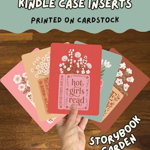May include: A set of rectangular cardstock inserts for Kindle cases, featuring various floral designs and book-themed text including "hot girls read" and "BORN TO READ". The cards are displayed in a fan shape, showcasing colors like pink, peach, red, and teal.