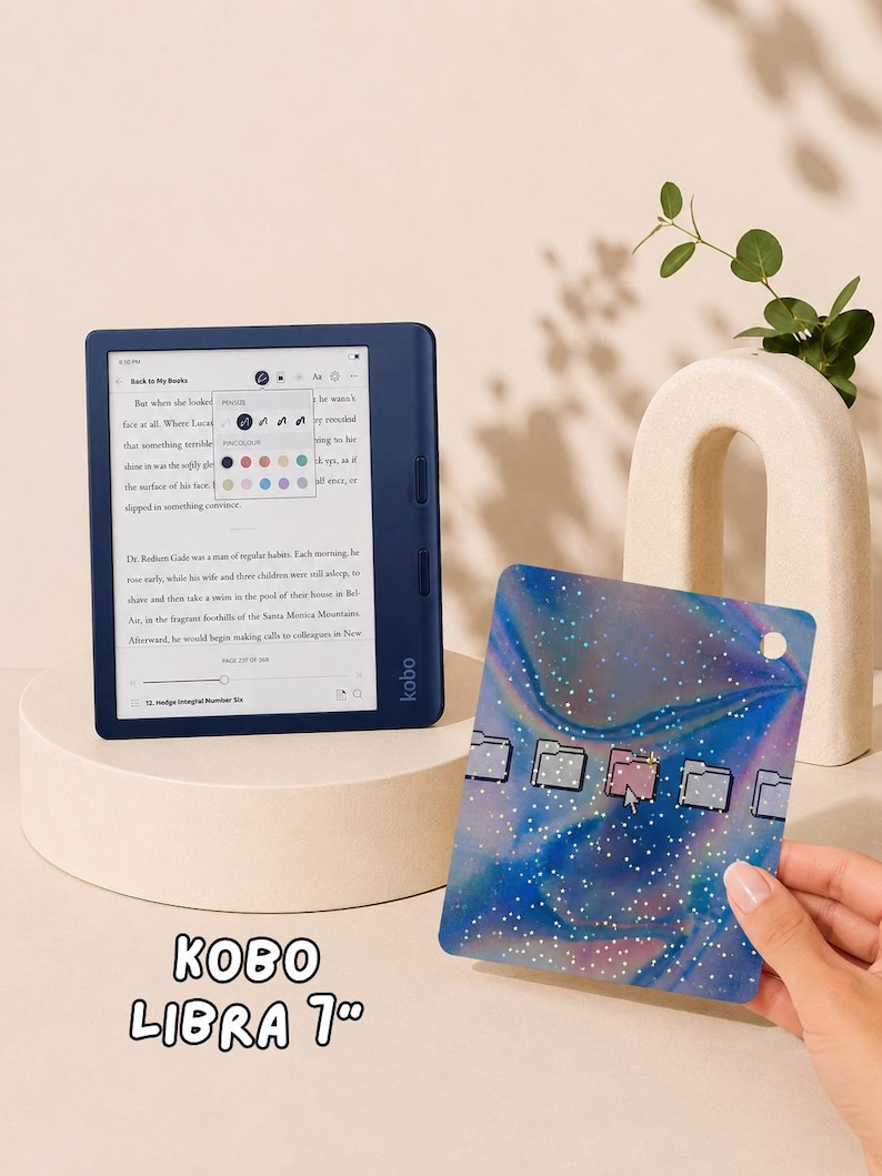 May include: A dark blue Kobo Libra 7-inch e-reader displaying a book page with a text settings menu. Beside it is a rectangular protective cover featuring a blue and purple holographic swirl pattern with white speckles and five folder icons.
