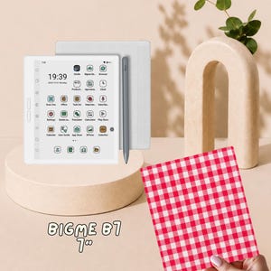 May include: A white Bigme B7 7-inch e-reader tablet with a digital screen displaying app icons, a time of 19:39, and a date of 2025-12-01. A grey stylus is attached to the side of the device. A red and white checkered square is held in the foreground.