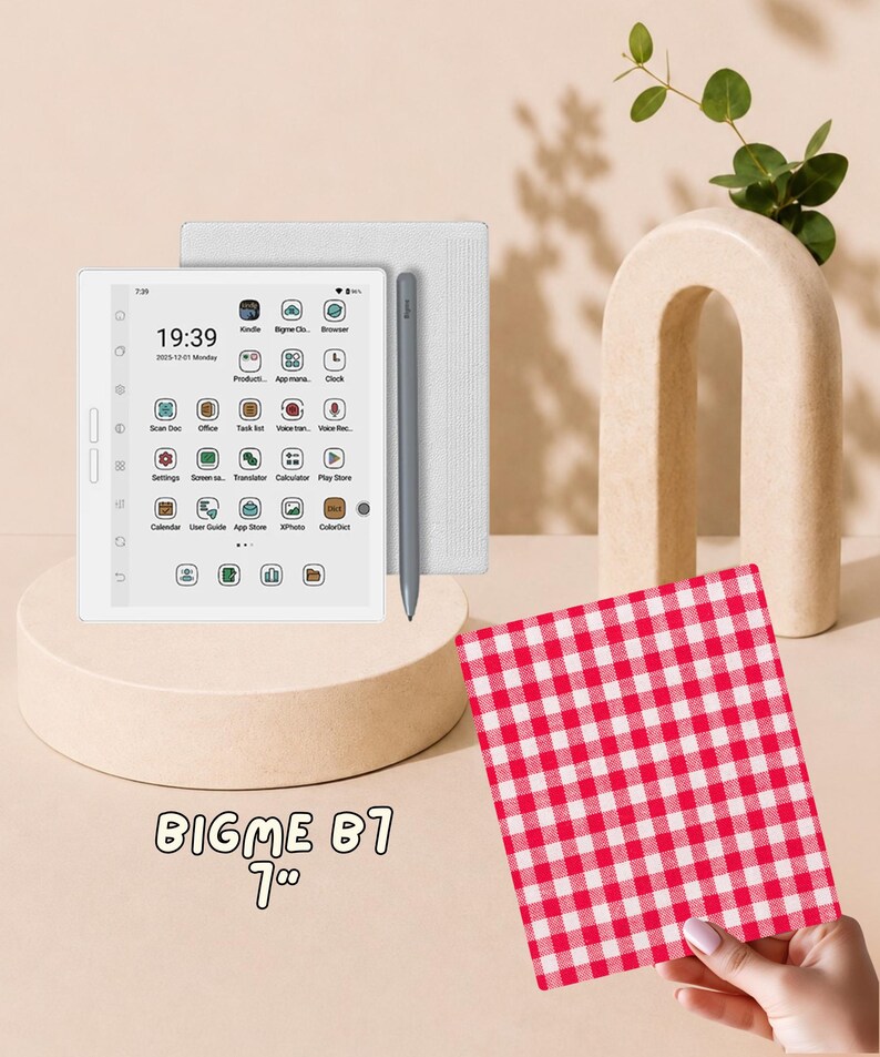 May include: A white Bigme B7 7-inch e-reader tablet with a digital screen displaying app icons, a time of 19:39, and a date of 2025-12-01. A grey stylus is attached to the side of the device. A red and white checkered square is held in the foreground.