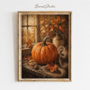 Può includere: Una stampa artistica incorniciata intitolata Berest Studio che raffigura una zucca arancione su una superficie di legno accanto a una brocca in ceramica piena di foglie autunnali, tela di iuta e fogliame vicino a una finestra luminosa.
