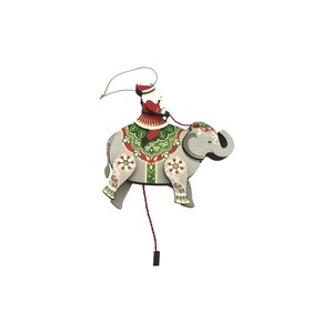 May include: A flat, articulated wooden ornament featuring a grey elephant with a decorative green, red, and white saddle. A figure dressed in a red Santa suit sits atop the elephant, holding reins. A thin string is attached for hanging.