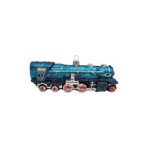 May include: A blue glass locomotive ornament featuring silver detailing, red accents on the wheels, and a circular emblem with the letter L on the side. The train has a metallic finish and includes a small silver loop at the top for hanging.