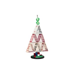 May include: A decorative structure shaped like a pyramid made from playing cards with red and black suits. The base features a stack of red, blue, and white poker chips on a green circular platform. Two translucent green dice top the card structure.