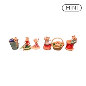 May include: A collection of six miniature mouse figurines interacting with sewing tools, including a thimble, scissors, a spool of green thread, a pincushion, a woven basket, and a red spool of thread. The text MINI is visible in the top right corner.