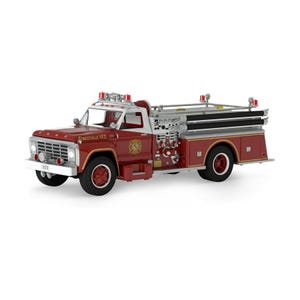 May include: A 1979 Ford fire truck model in red and white with silver accents. The vehicle features the text Forestville V.F.D. on the side, a chrome grille, emergency lights on the roof, black tires, and a detailed rear pump and hose assembly.
