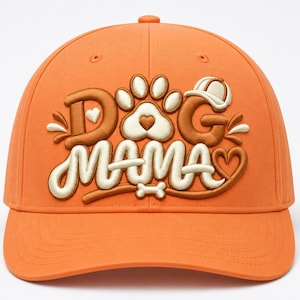 May include: An orange baseball cap featuring embroidered text that reads DOG MAMA in brown and cream colors. The design includes a paw print with a heart in the center, a small bone, and a tiny cap icon above the letter G, all in a puffy style.