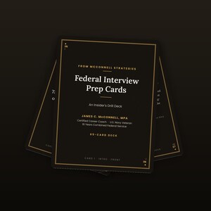 May include: A black deck of 65 Federal Interview Prep Cards from McConnell Strategies. The front card features white and gold text, including the title, the author James C. McConnell, MPA, and the label An Insider's Drill Deck with gold borders.