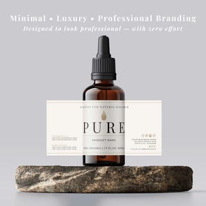 May include: A brown glass bottle with a black dropper top, labeled "PURE" and "1.7 FL. OZ.". The bottle sits on a stone, with text above reading "Minimal &bull; Luxury &bull; Professional Branding". The label also says "CERTIFIED FOR NATURAL RADIANCE".