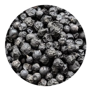 May include: A close-up shot of a collection of dried, dark blue juniper berries. The berries are spherical and have a slightly wrinkled texture. The image is set against a white background, highlighting the berries' colour and texture. These berries are often used in cooking and herbal remedies.