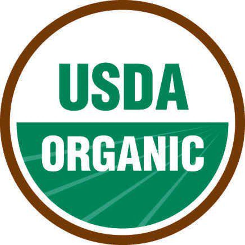 May include: A circular USDA Organic seal with a brown border. The top half of the circle is white with the word "USDA" in green block letters. The bottom half is green with the word "ORGANIC" in white block letters.