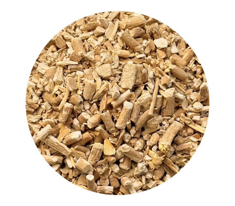 May include: A close-up shot of a collection of light brown, chopped wood pieces, bark, and stems. The pieces are of varying sizes and shapes, some cylindrical and others irregular. The background is plain white.