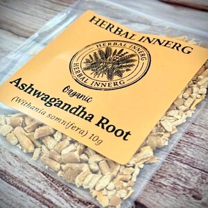 May include: A transparent bag containing dried Ashwagandha root, with a yellow label. The label reads "HERBAL INNERG" and "Ashwagandha Root", with a weight of 10g. The root pieces are light brown.